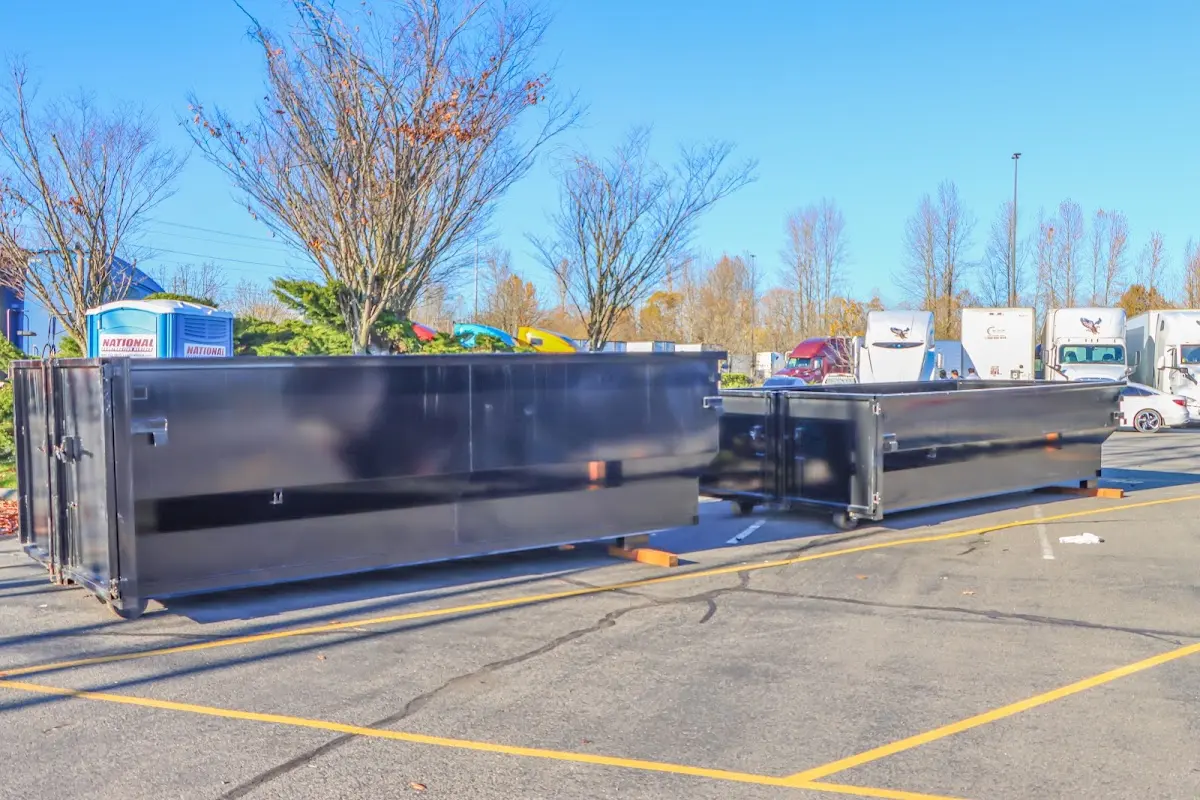 Professional dumpster rental service with roll-off container on residential driveway in Josephine